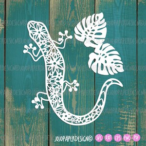 May include: White silhouette of a gecko with a floral pattern and two monstera leaves on a teal wood background.