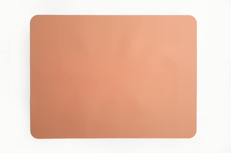 May include: A light peach-colored rectangular placemat.