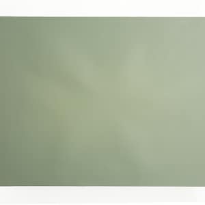 May include: A sage green rectangular placemat made of a textured material.