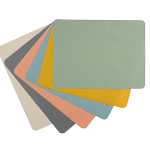 May include: A set of six placemats in various colors, including gray, beige, light blue, peach, yellow, and green. The placemats are made of a smooth, non-slip material and are perfect for protecting your table from scratches and spills.