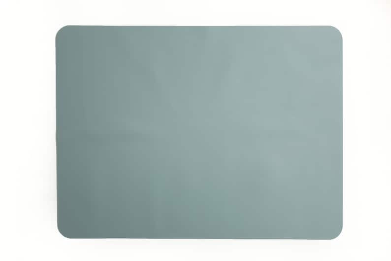 May include: A light blue rectangular silicone placemat.