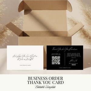 May include: Two business thank you cards, one white and one black, with elegant script. The white card reads "We Hope You Love it as Much as We Do." The black card includes a QR code and a discount offer. A brown cardboard box is in the background.