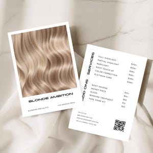 May include: Two white cards with the text "BLONDE AMBITION" and a list of hair services. One card features a close-up of wavy blonde hair. The other card lists services like full highlight, babylight, and root touch-up.