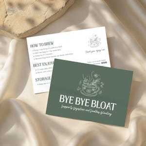 May include: Two cards with tea instructions and product information. One card is white with brewing instructions and a floral teacup illustration. The other is a dark green card with the text "BYE BYE BLOAT" and a teacup illustration.