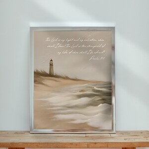May include: A watercolor painting of a lighthouse on a beach with waves crashing on the shore. The painting has a quote from Psalm 27:1, "The Lord is my light and my salvation: whom shall I fear? The Lord is the strength of my life; of whom shall I be afraid!"