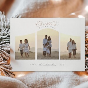 May include: A Christmas card with a white background and a pink inscription that reads "Christmas Blessings". The card features three photos of a family on a beach. The first photo shows two children running on the beach. The second photo shows a family of four standing on the beach. The third photo shows a couple walking on the beach. The card also includes the text "Love, The Whittakers 20XX".