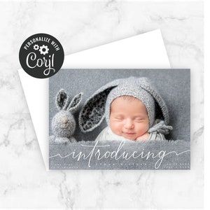 Introducing Baby script in white on full-bleed photo announcement