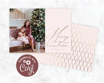 May include: A pink Christmas card with a gold foil design. The card features a photo of a mother and daughter in front of a Christmas tree. The text on the card reads "Merry Christmas The Christiansons 20XX".