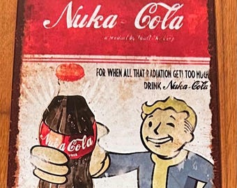 May include: Vintage metal sign featuring the Nuka-Cola logo and a cartoon character. The sign has a distressed, aged appearance with the text "FOR WHEN ALL THAT RADIATION GETS TOO MUCH DRINK Nuka-Cola". The sign is rectangular and has a red and white color scheme.