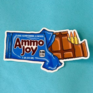 May include: A sticker with a blue wrapper design that reads "Ammo Joy" with the text "Lead, Gunpowder, & Nickel" above it. The sticker shows a chocolate bar with bullets. The sticker is 1 lb (55 gr) and has 5.56 calories.