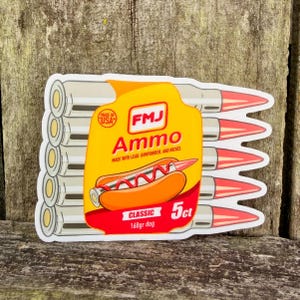 May include: A sticker featuring a yellow and red design resembling a hot dog with the text "FMJ Ammo." The sticker includes images of bullets and the text "MADE IN USA." The text "CLASSIC 168gr dog 5ct" is also present.