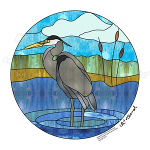 May include: A stained glass design of a blue heron standing in a blue pond with reeds in the background. The design is in a circle with the words "12" and "round" written on the bottom right.