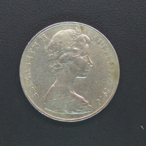 May include: Silver Australian coin featuring a profile of Queen Elizabeth II with the inscription "ELIZABETH II AUSTRALIA 1970".
