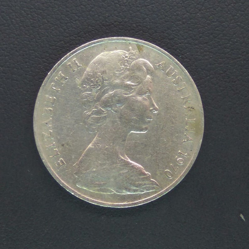 May include: Silver Australian coin featuring a profile of Queen Elizabeth II with the inscription "ELIZABETH II AUSTRALIA 1970".