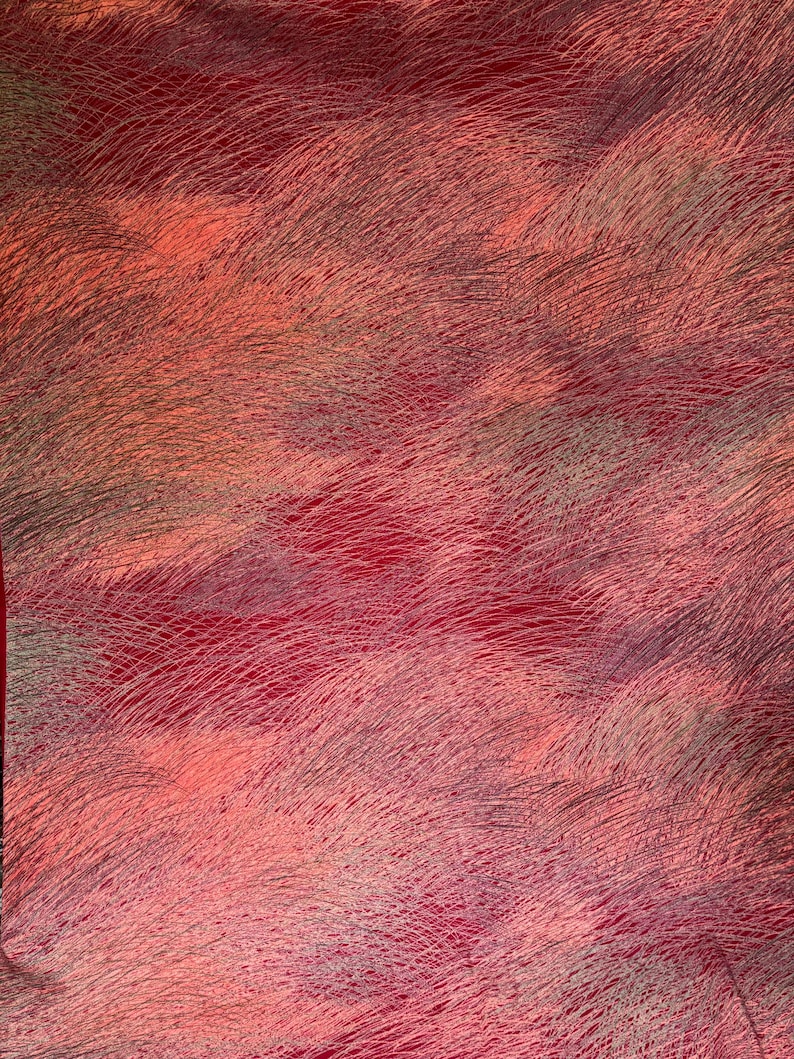 May include: Abstract textile with a textured, layered appearance. The fabric features a blend of red, pink, and gray hues, with a pattern of fine, curved lines creating a sense of movement and depth. The overall effect is a soft, flowing design.