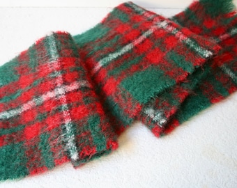 May include: A red, green, and white plaid scarf with a fuzzy texture.
