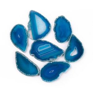May include: Seven blue agate slices with natural edges and a hole drilled at the top. The agate slices have a variety of patterns and textures.