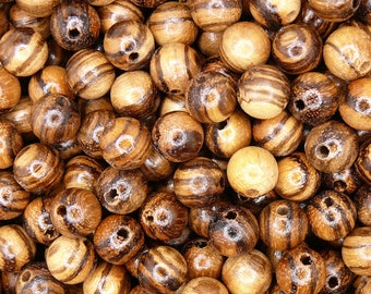 May include: A close-up of a pile of brown and black wooden beads. The beads are round and have a natural wood finish. They are perfect for crafting jewelry or other projects.