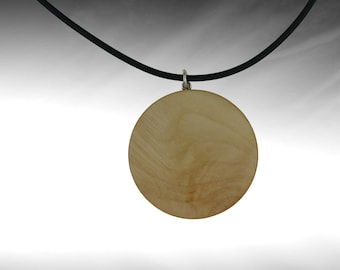 Wooden pendant made of hazelnut wood, round shape with rubber band and a lobster clasp made of 925 silver.