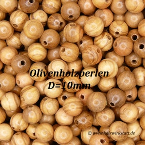 Könnte beinhalten: Nahaufnahme einer Ansammlung von natürlichen Holzperlen. Die Perlen sind rund und haben eine glatte, polierte Oberfläche. Die Perlen haben einen Durchmesser von 10 mm und sind aus Olivenholz gefertigt. Der Text "Olivenholzperlen D=10mm" ist auf dem Bild sichtbar.