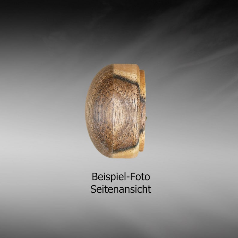 May include: Side view of a wooden knob with a dark brown and light brown wood grain pattern. The knob is round and has a smooth surface.