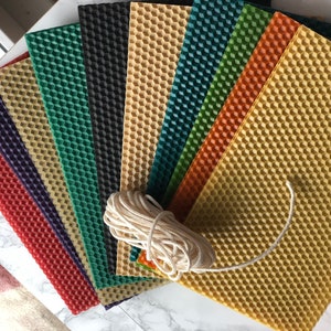 May include: Assortment of colourful beeswax sheets with a honeycomb pattern, ideal for candle making. A ball of white cotton wick is included.
