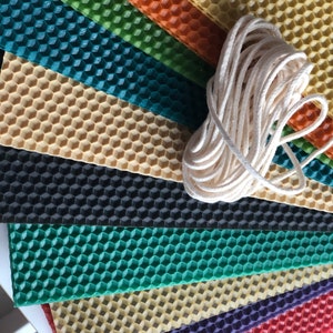 May include: Assortment of colourful honeycomb wax sheets for candle making, with a spool of white cotton wick.