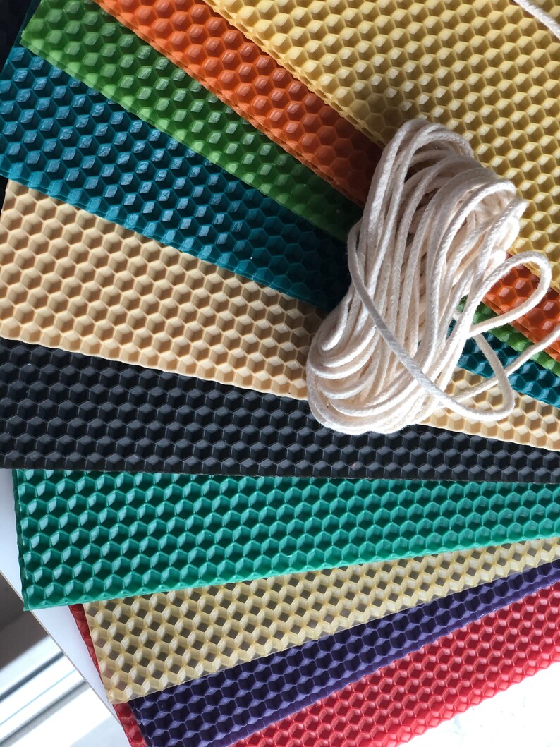 May include: Assortment of colourful honeycomb wax sheets for candle making, with a spool of white cotton wick.