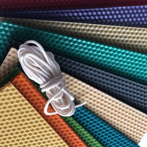 May include: A set of nine honeycomb wax sheets in various colours, including red, purple, green, and yellow, with a roll of white twine.