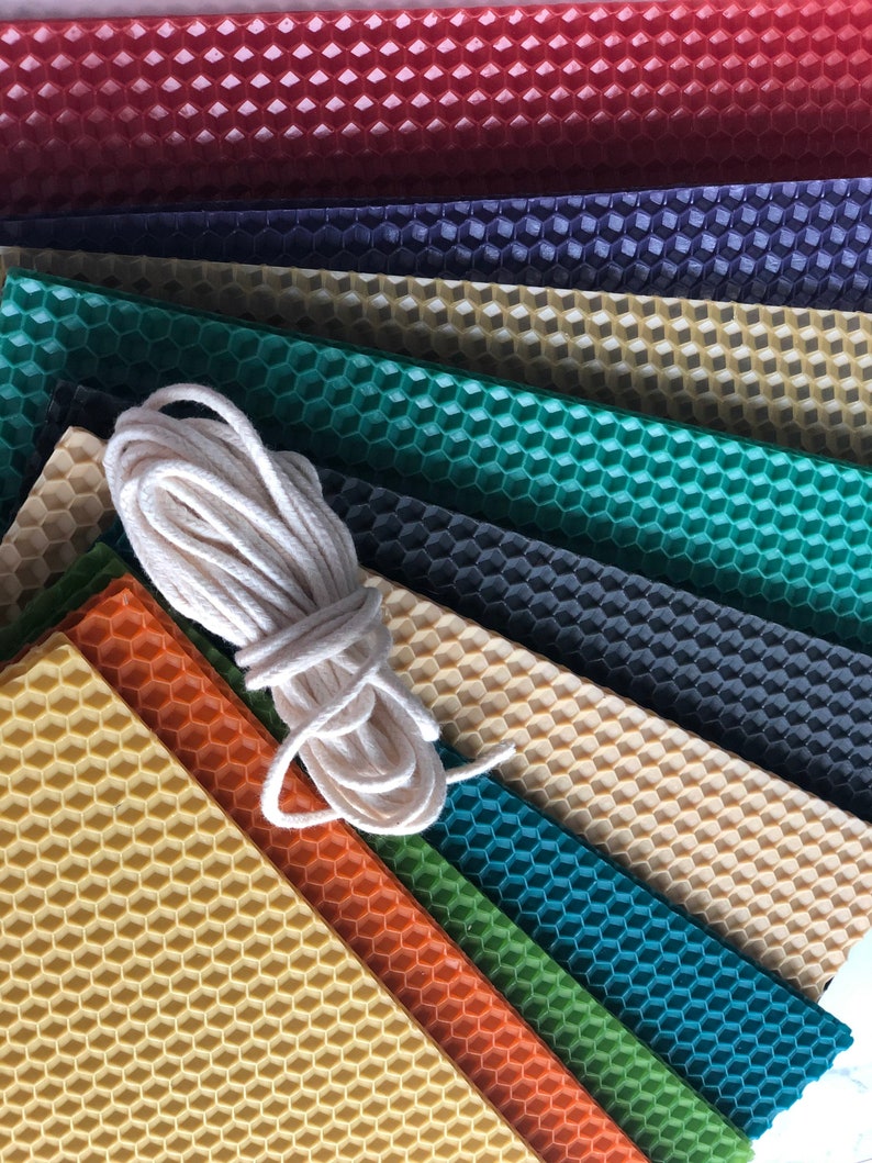 May include: A set of nine honeycomb wax sheets in various colours, including red, purple, green, and yellow, with a roll of white twine.