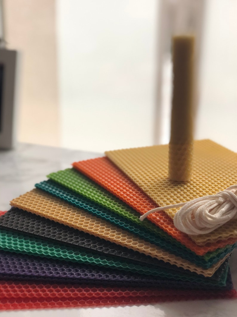 May include: A set of colourful honeycomb wax sheets for candle making, with a white cotton wick and a single beeswax candle.