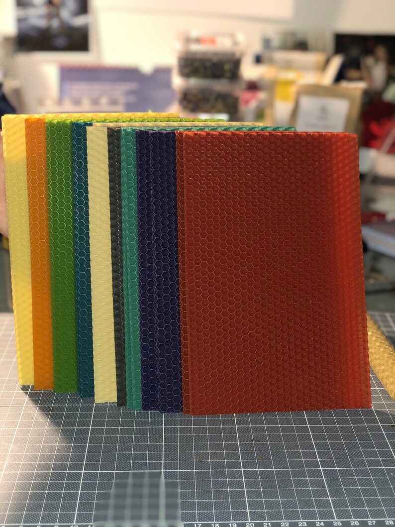 May include: A set of 10 sheets of honeycomb foundation for beekeeping. The sheets are in various colours, including orange, yellow, green, blue, and red.