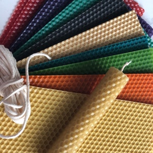 May include: Assortment of honeycomb wax sheets in various colours, including red, green, blue, and orange, with a single honeycomb wax candle and a spool of white twine.