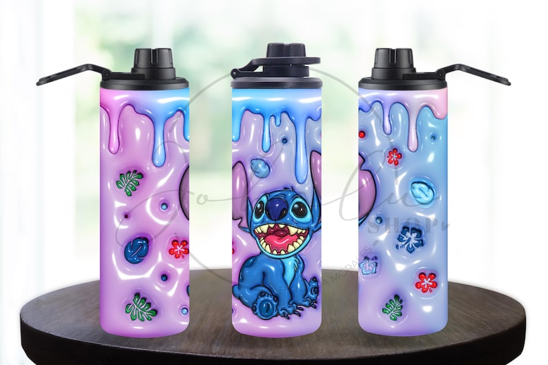 May include: Three insulated water bottles with black lids. The bottles feature a design of a blue cartoon character with large eyes and a wide grin, set against a purple and blue background with floral accents. The bottles are cylindrical and sit on a dark wooden surface.
