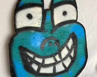 Large spray painted character wall hanging