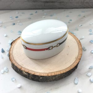 Vintage Red and Gold Limoges Box. Oval Limoges trinket. Red Limoges box accented w/ gold. Lidded Limoges trinket box. Made in Limoges France