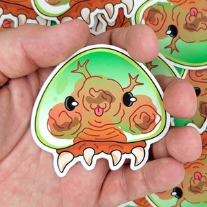 Metroid Cute Alien Vinyl Sticker – waterproof nintendo stickers – samus stickers – gifts for gamers – transparent metroid funny decal