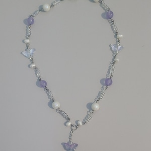 Purple and white pearl iridescent beaded butterfly charm necklace