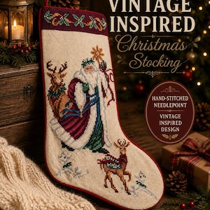 May include: A cream-coloured Christmas stocking featuring hand-stitched needlepoint embroidery of a bearded figure in a long robe, two reindeer, and a star. The stocking has a dark red border and a hanging loop at the top.