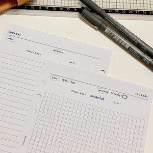 May include: A white journal page with a grid pattern. The page has headings for "Date", "Today Was A", "Weather", and "Day!" The date is written as "15th. Jan" and the weather is written as "Cloudy" with a cloud drawing. The words "wonderful" and "JOURNAL" are also written on the page.