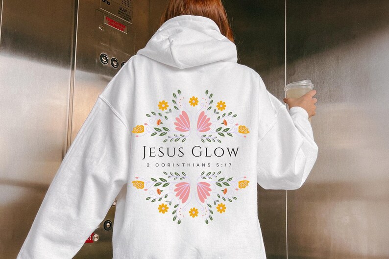 May include: White hoodie with a floral design and the text "JESUS GLOW 2 CORINTHIANS 5:17" printed on the back.
