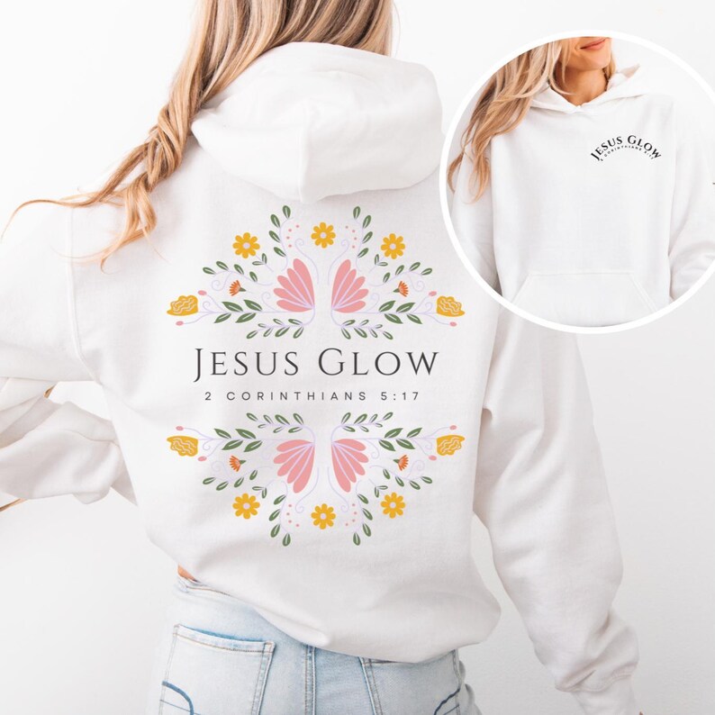May include: White hoodie with a floral design and the text "JESUS GLOW 2 CORINTHIANS 5:17" on the back. The front of the hoodie has the text "JESUS GLOW" in a small circle.