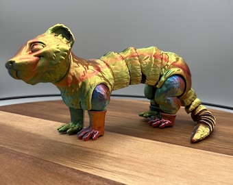 May include: A multi-colored, segmented, articulated figurine of a weasel or ferret. The figurine is made of plastic and has a glossy finish. The figurine is posed in a running position with its tail curled up.