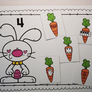 May include: A printable worksheet featuring a cartoon bunny with the number 4. There are five cards with carrots, each showing a different way to represent the number four: the word "four", four dots, a dice with four dots, a hand with four fingers, and four lines.