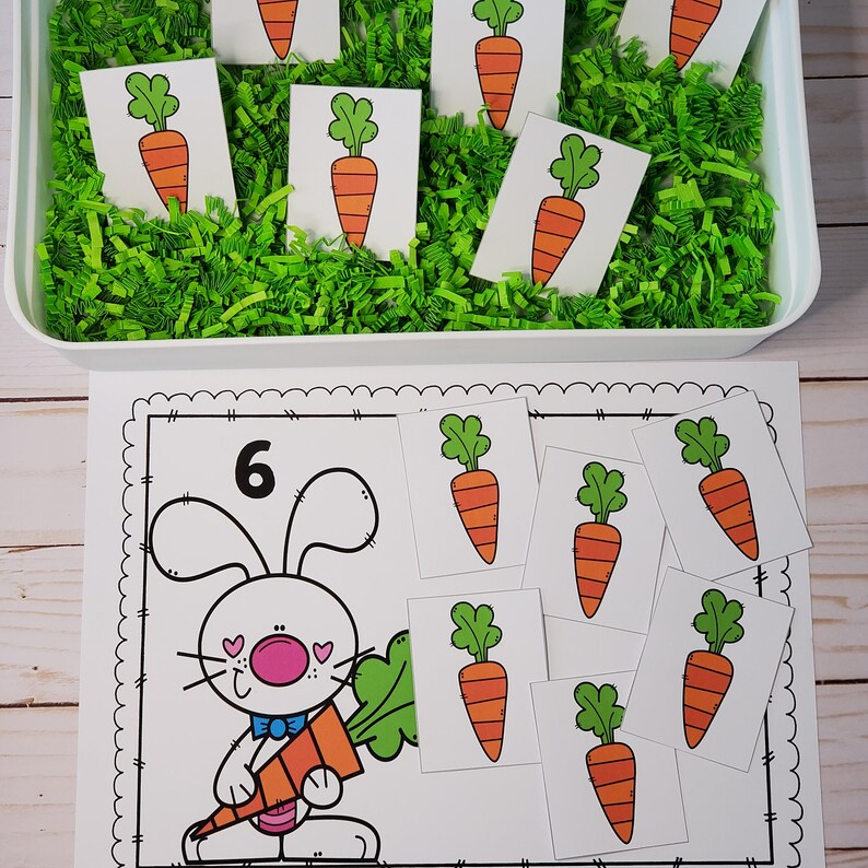 May include: A printable Easter counting activity featuring a bunny holding a carrot and a number 6. There are six carrot images to count and match to the number.