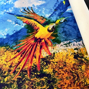 May include: A painting of two parrots in flight against a blue sky with white clouds. The parrots are yellow and orange with long red tails. The background includes green trees and a city skyline.