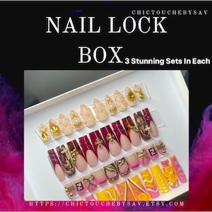 May include: A white box displaying three sets of artificial nails. The nails feature various designs, including gold embellishments, French tips, and patterned accents. Text on the image reads "NAIL LOCK BOX" and "3 Stunning Sets In Each Box."