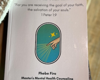 May include: A pink and white book titled "565 Days Biblical Mental Healing" with the quote "For you are receiving the goal of your faith, the salvation of your souls." 1 Peter 1:9. The book cover features a blue oval with a hand reaching out from a light blue cloud with yellow stars. The book is by Phebe Fire, Master's Mental Health Counseling.
