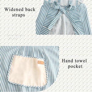 May include: Blue and white striped apron with widened back straps and a hand towel pocket. The apron has a cream-colored pocket with a brown label. The text "Widened back straps" and "Hand towel pocket" are visible.