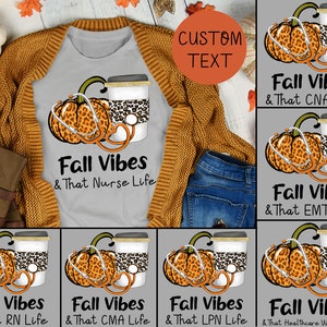 May include: A grey t-shirt with a graphic design of a pumpkin with a stethoscope and a coffee cup. The text on the shirt reads "Fall Vibes & That Nurse Life".